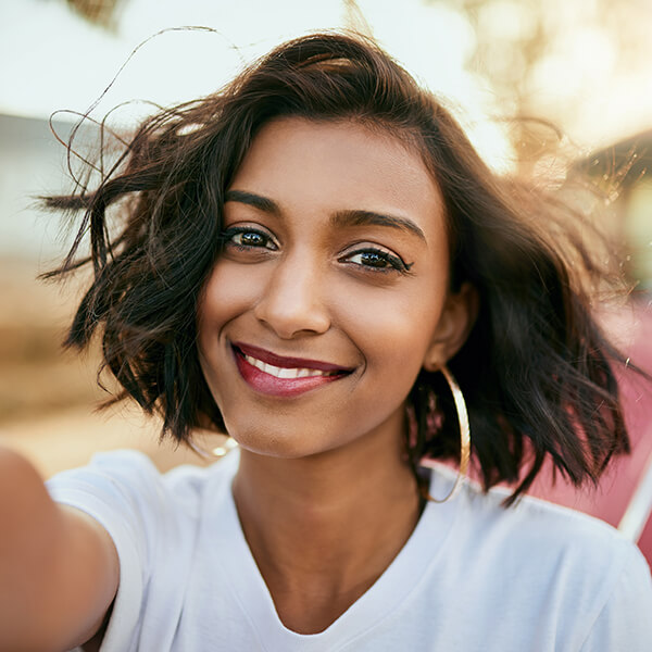 A woman smiling while taking a selfie