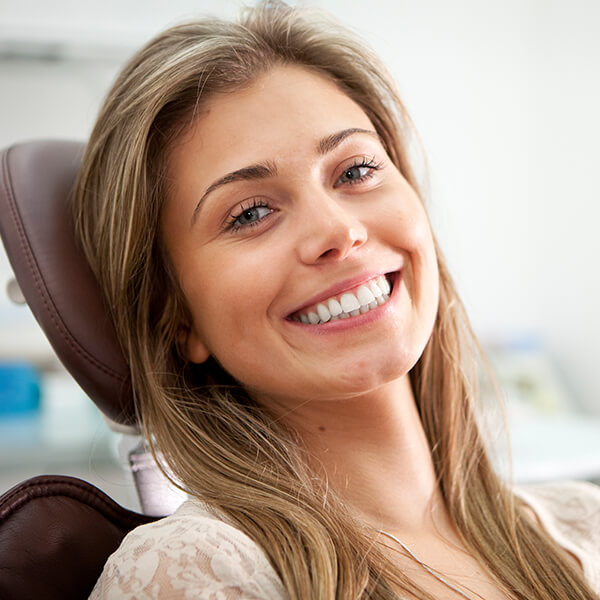 Woman in a dental chair smiling